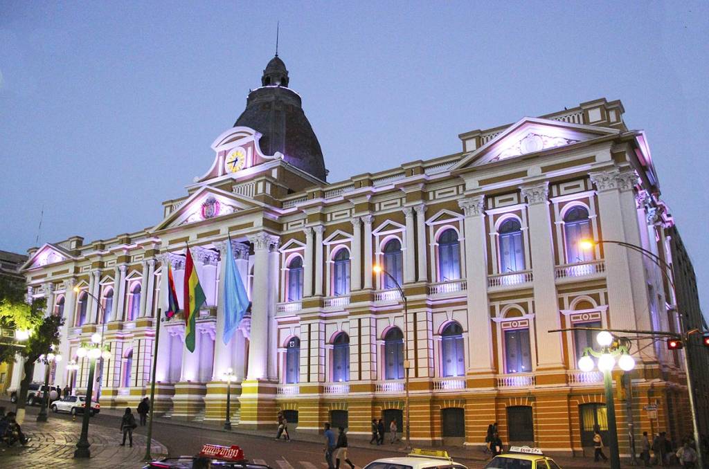O Palácio Presidencial da Bolívia tem o brasão do país na fachada e hoje - com a gestão do primeiro indígena da história, Evo Morales, também carrega uma bandeira quadriculada e colorida, representando o símbolo dos povos pré-colombianos O Palácio Presidencial da Bolívia tem o brasão do país na fachada e hoje - com a gestão do primeiro indígena da história, Evo Morales, também carrega uma bandeira quadriculada e colorida, representando o símbolo dos povos pré-colombianos