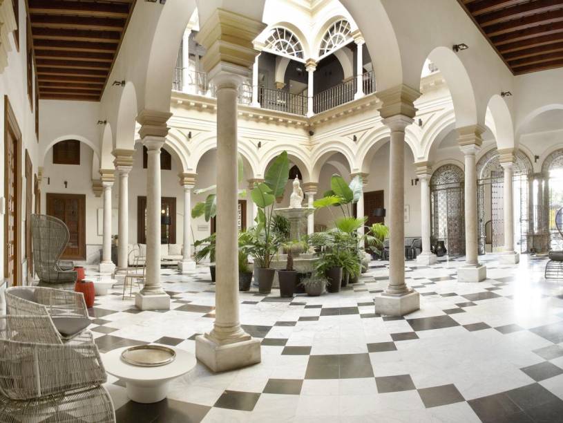 <strong><a href="https://www.booking.com/hotel/es/hotel-palacio-de-villapanes.en-gb.html" rel="Hotel Palacio de Villapanés">Hotel Palacio de Villapanés</a>, Sevilha, Espanha (Palácio Real de Dorne) </strong> É missão árdua contar os palácios monumentais que existem no mundo de Game of Thrones. Na vida real, um deles fica na Espanha: é o caso do Hotel Palacio de Villapanés, uma construção restaurada que data o século XVIII e que fica localizada nos arredores do distrito de Santa Cruz, em Sevilha. Para quem aprecia as cenas com banquetes regados a vinho e torta de pombo, o lugar conta com salões elegantes, um restaurante sublime que serve cozinha tradicional da Andaluzia e um terraço que serve tapas. Além disso, ele fica a apenas 10 minutos a pé do Real Alcázar Palace, locação de filmagem do Palácio Real de Dorne. <strong><a href="https://www.booking.com/hotel/es/hotel-palacio-de-villapanes.en-gb.html" rel="Hotel Palacio de Villapanés">Hotel Palacio de Villapanés</a>, Sevilha, Espanha (Palácio Real de Dorne) </strong> É missão árdua contar os palácios monumentais que existem no mundo de Game of Thrones. Na vida real, um deles fica na Espanha: é o caso do Hotel Palacio de Villapanés, uma construção restaurada que data o século XVIII e que fica localizada nos arredores do distrito de Santa Cruz, em Sevilha. Para quem aprecia as cenas com banquetes regados a vinho e torta de pombo, o lugar conta com salões elegantes, um restaurante sublime que serve cozinha tradicional da Andaluzia e um terraço que serve tapas. Além disso, ele fica a apenas 10 minutos a pé do Real Alcázar Palace, locação de filmagem do Palácio Real de Dorne.