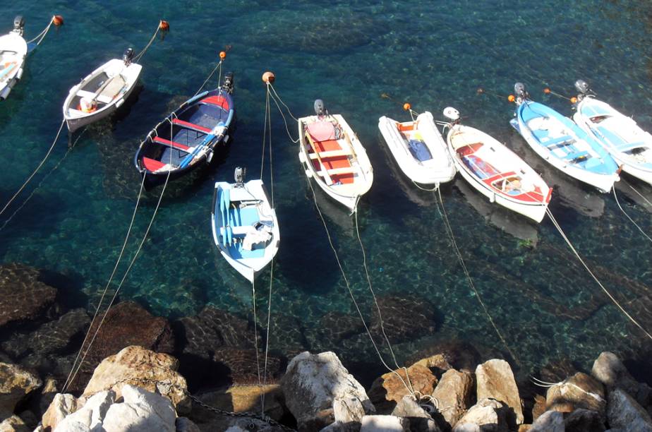 Vista do mar esmeralda e seus barcos de pescadores na cidade de Manarola, Regi&atilde;o de Cinque Terre, It&aacute;lia