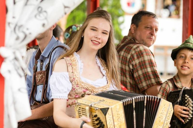 Menina toca bandone&oacute;n durante a Festa Pomerana.