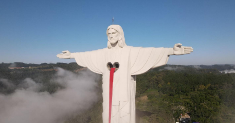 A obra mostra uma grande estátua cinza claro do Cristo que possui um coração no meio do peito.